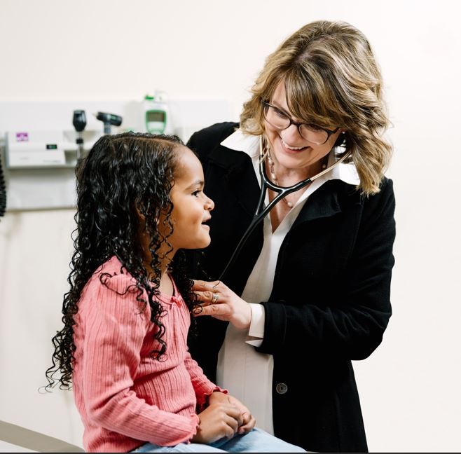 photo of teri rosselle looking at child